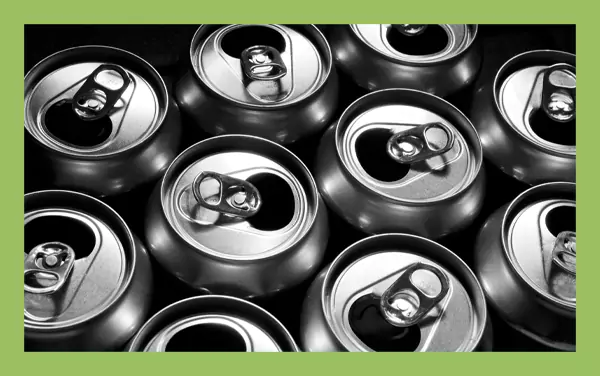 Top-down view of multiple soda cans, a common curved surface that complicates barcode placement.