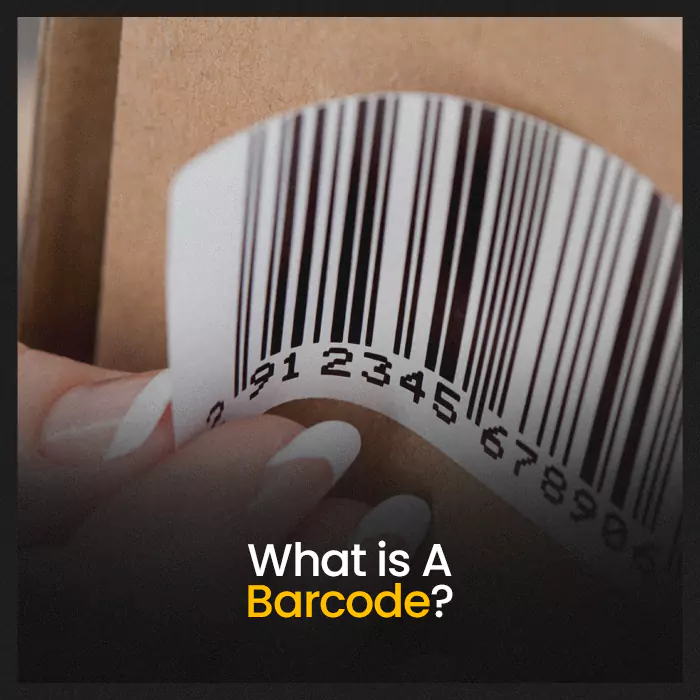Close-up of a hand peeling a barcode label from cardboard packaging, showing a standard 1D barcode for product identification